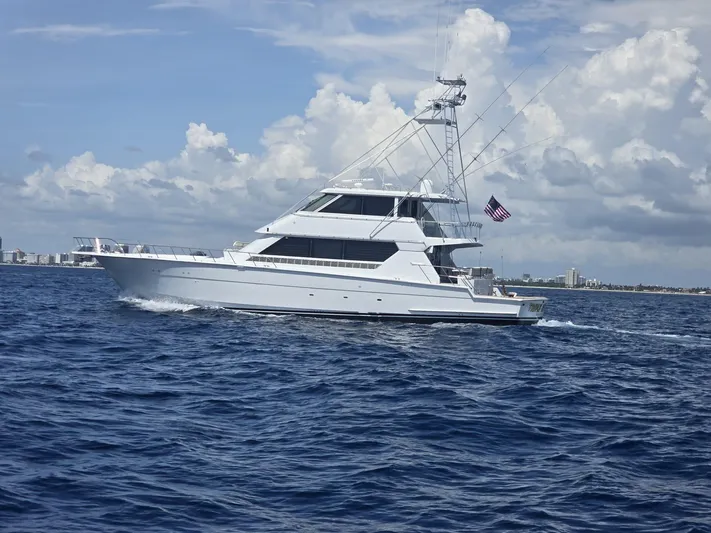 Triple Net II Yacht Photos Pics 1994 Hatteras 82 Convertible yacht cruising on open water under a cloudy sky.