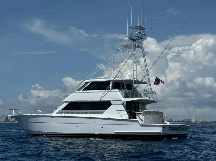 Triple Net II Yacht Photos Pics 1994 Hatteras 82 Convertible yacht cruising on open water under a clear sky.