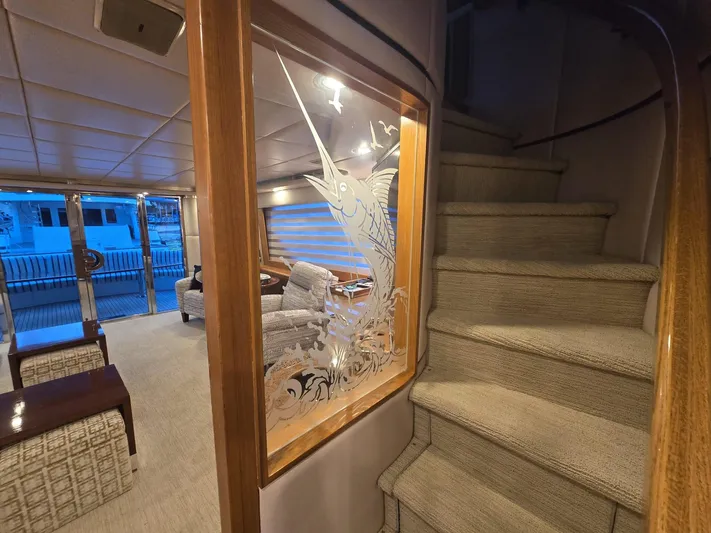 Triple Net II Yacht Photos Pics Interior of 1994 Hatteras 82 Convertible yacht with elegant staircase and etched glass artwork.