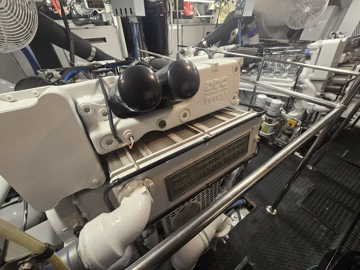 Triple Net II Yacht Photos Pics Engine room of a 1994 Hatteras 82 Convertible yacht, showcasing machinery and components.