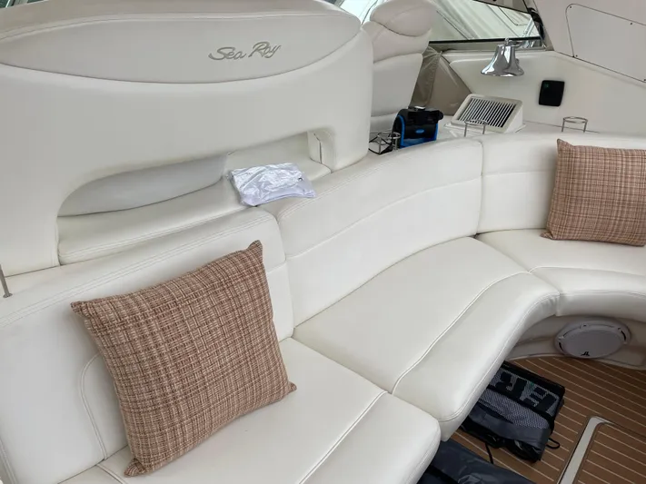 Lisa Ann Yacht Photos Pics Luxurious interior of 2003 Sea Ray 460 Sundancer yacht with white seating and cushions.
