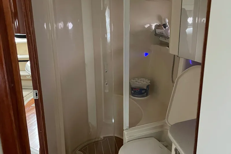 Lisa Ann Yacht Photos Pics Bathroom interior of 2003 Sea Ray 460 Sundancer yacht, featuring shower and toilet.