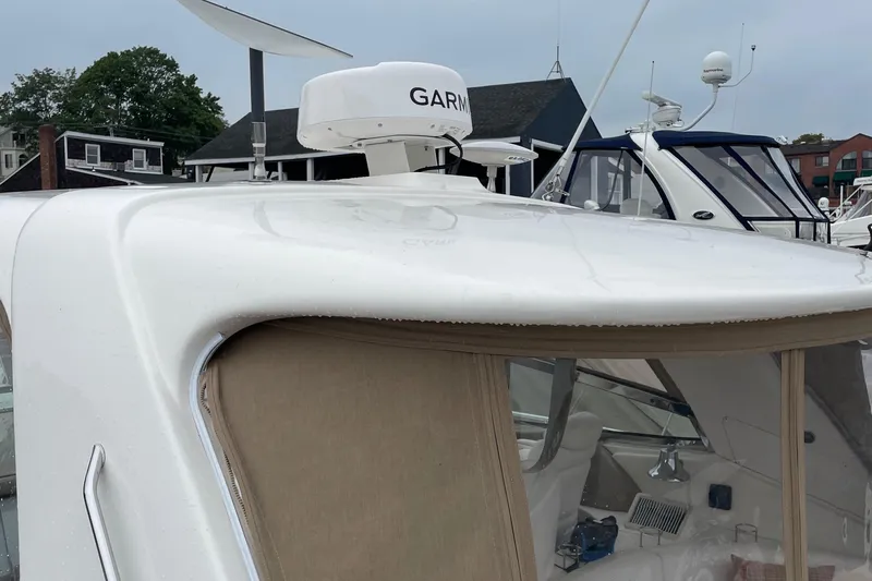 Lisa Ann Yacht Photos Pics 2003 Sea Ray 460 Sundancer yacht with Garmin radar, docked in a marina.