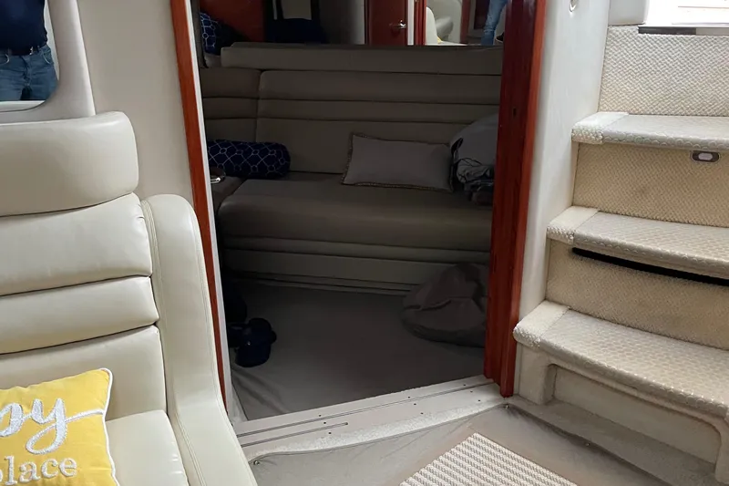 Lisa Ann Yacht Photos Pics Interior of 2003 Sea Ray 460 Sundancer yacht with beige seating and carpeted stairs.