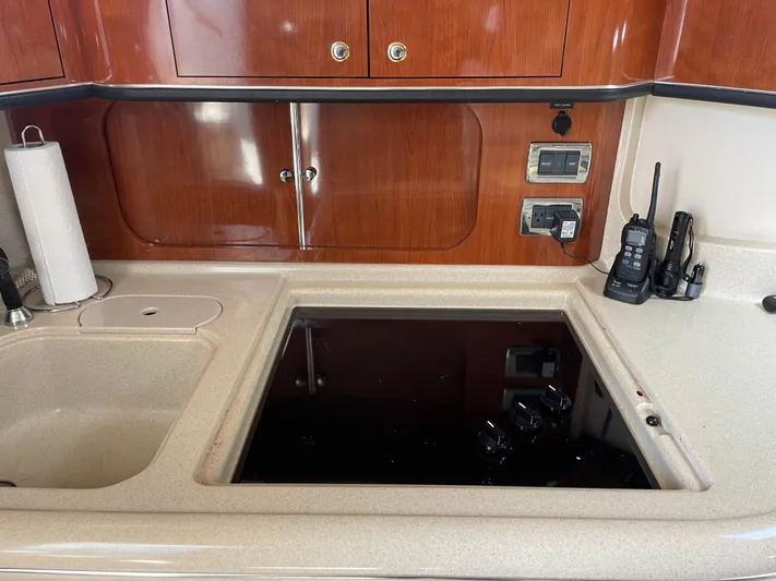 Lisa Ann Yacht Photos Pics Kitchen area of 2003 Sea Ray 460 Sundancer yacht with stove and radio equipment.
