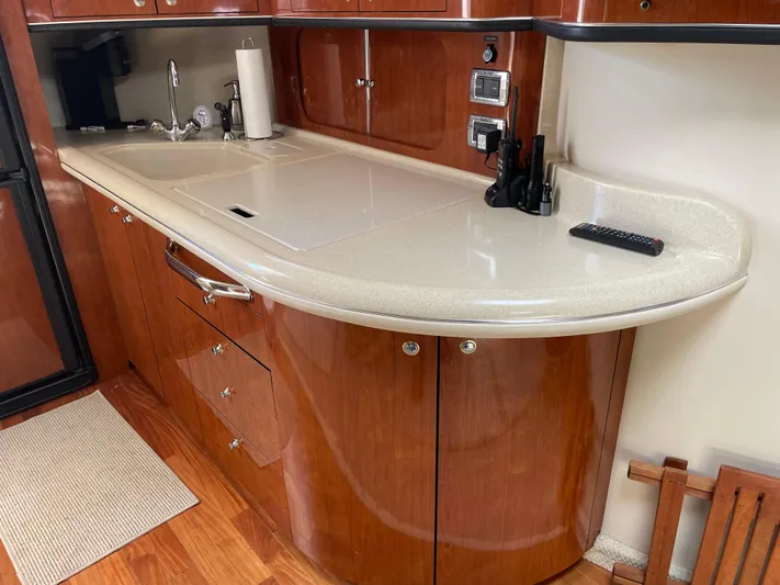 Lisa Ann Yacht Photos Pics Luxurious kitchen area in a 2003 Sea Ray 460 Sundancer yacht with wood cabinetry.