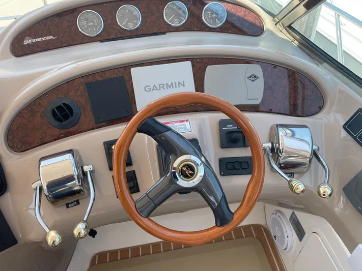 Lisa Ann Yacht Photos Pics 2003 Sea Ray 460 Sundancer helm with Garmin navigation and wooden steering wheel.