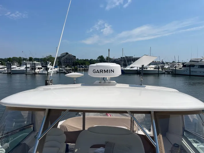 Lisa Ann Yacht Photos Pics 2003 Sea Ray 460 Sundancer with Garmin radar, docked at a marina under a clear blue sky.