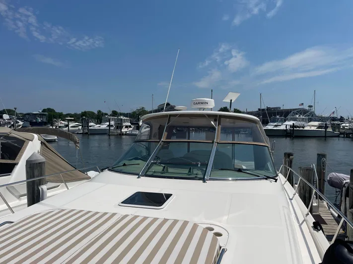 Lisa Ann Yacht Photos Pics 2003 Sea Ray 460 Sundancer yacht docked at a marina under a clear blue sky.