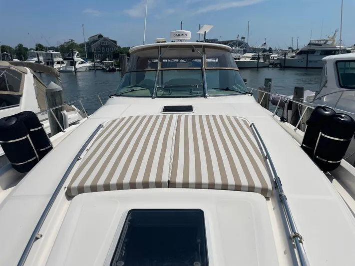 Lisa Ann Yacht Photos Pics 2003 Sea Ray 460 Sundancer yacht docked at marina, featuring striped sun pad.