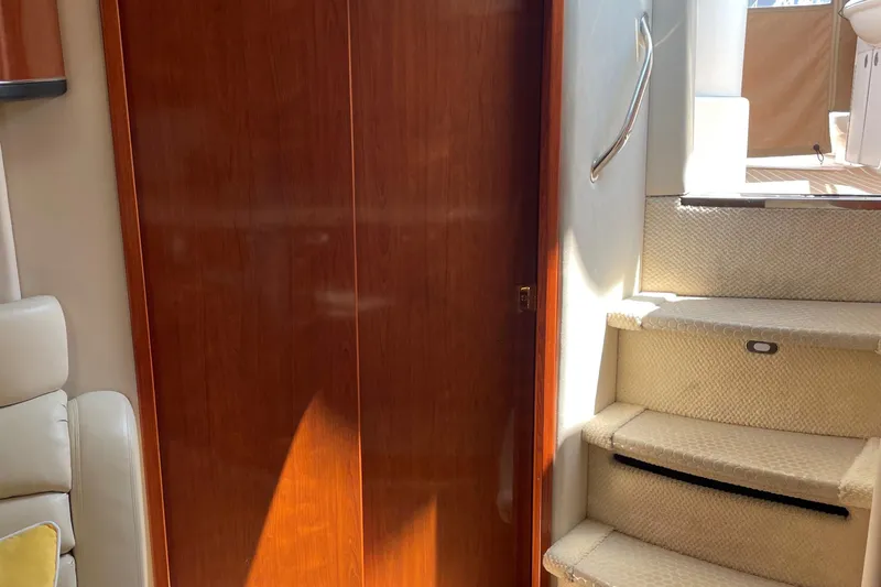 Lisa Ann Yacht Photos Pics Interior of 2003 Sea Ray 460 Sundancer with wooden door and carpeted stairs.