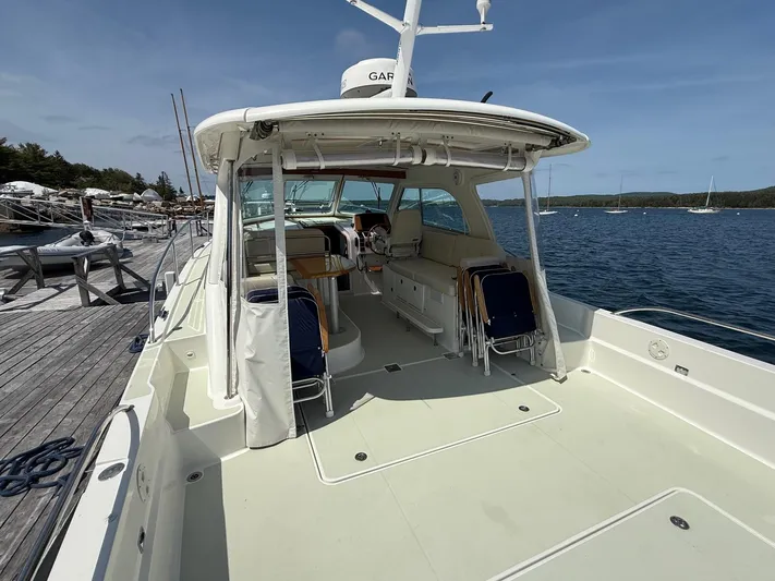 Wahoowa Yacht Photos Pics 2019 Back Cove Downeast boat docked, featuring spacious deck and seating area.