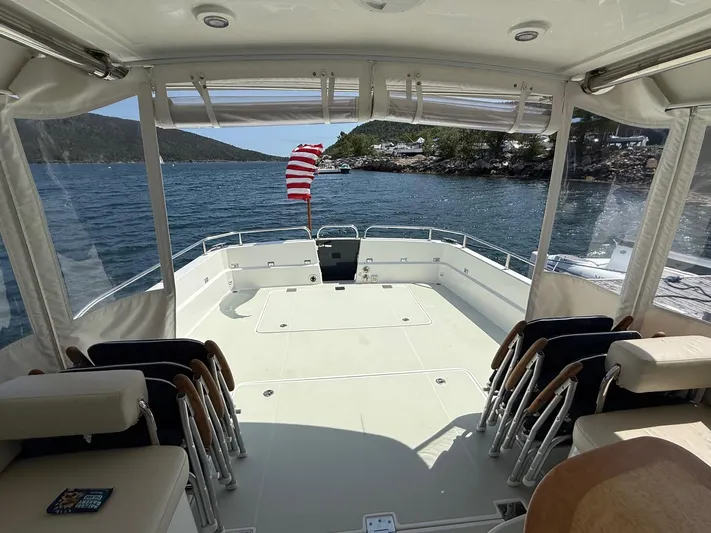 Wahoowa Yacht Photos Pics 2019 Back Cove Downeast boat interior with seating, open deck, and scenic water view.