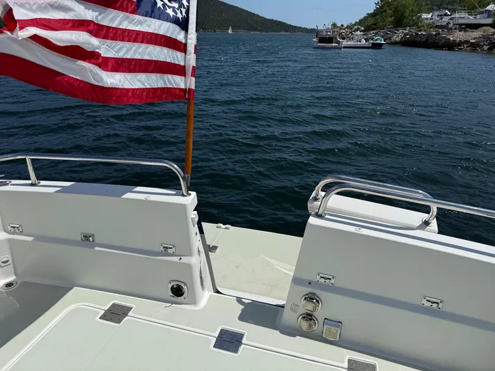 Wahoowa Yacht Photos Pics 2019 Back Cove Downeast boat with American flag on a scenic waterway.
