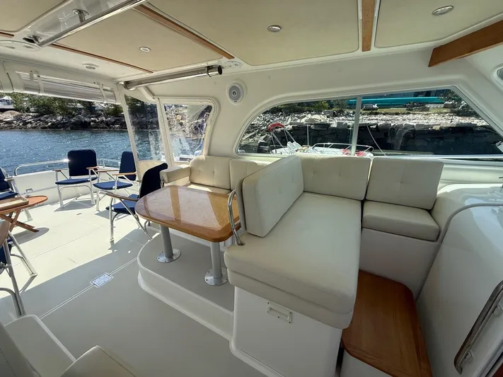 Wahoowa Yacht Photos Pics 2019 Back Cove Downeast boat interior with seating, table, and waterfront view.