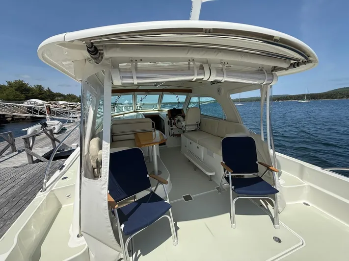Wahoowa Yacht Photos Pics 2019 Back Cove Downeast boat interior with seating, docked by the water.