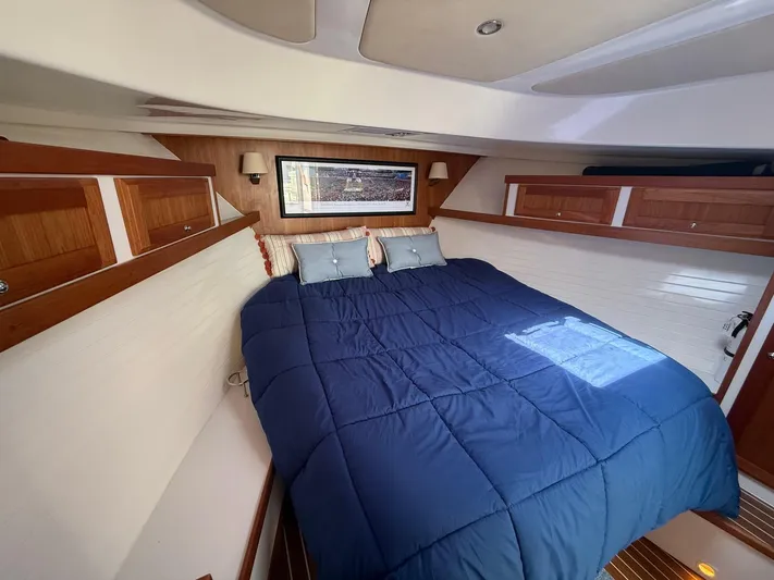Wahoowa Yacht Photos Pics 2019 Back Cove Downeast cabin with cozy bed, wooden accents, and nautical decor.