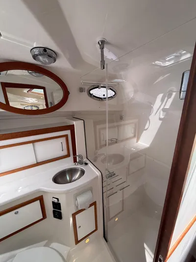 Wahoowa Yacht Photos Pics 2019 Back Cove Downeast boat bathroom with sink, shower, and mirror.