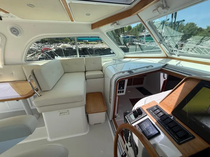 Wahoowa Yacht Photos Pics 2019 Back Cove Downeast boat interior with seating, navigation controls, and large windows.