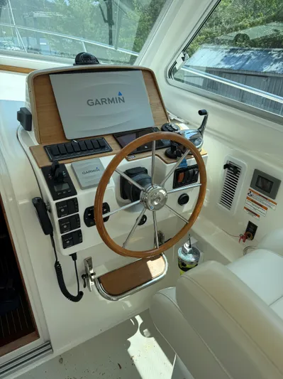 Wahoowa Yacht Photos Pics 2019 Back Cove Downeast helm with Garmin navigation system and wooden steering wheel.