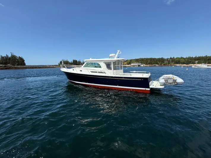 Wahoowa Yacht Photos Pics 2019 Back Cove Downeast boat on calm water under clear blue sky.