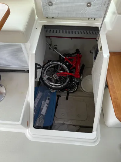 Wahoowa Yacht Photos Pics Storage compartment on 2019 Back Cove Downeast boat with a folded red bicycle inside.