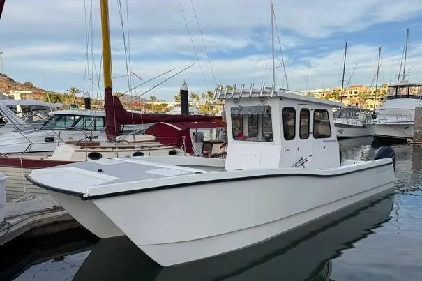  Yacht Photos Pics Custom 2021 Pilot House Catamaran docked in marina, surrounded by other boats.