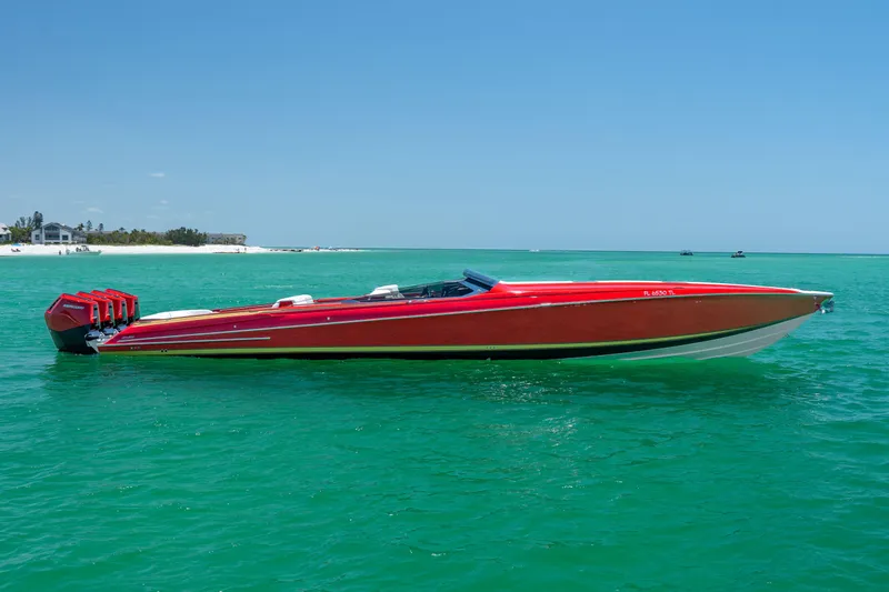 Lady Lisa Yacht Photos Pics 2023 Nor-Tech 55 Flyer speedboat in vibrant red on turquoise water.