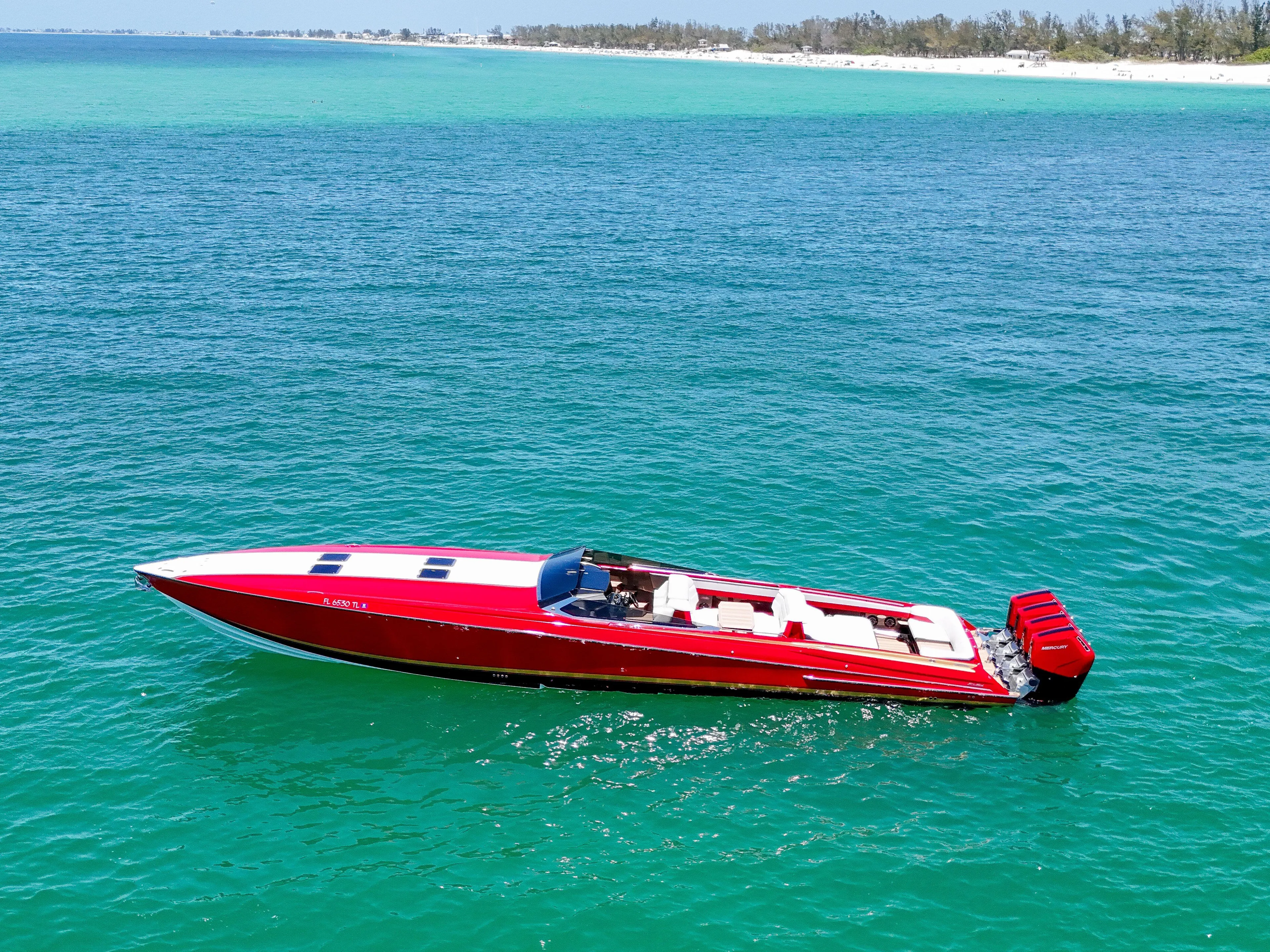 Lady Lisa Yacht Photos Pics 2023 Nor-Tech 55 Flyer speedboat on turquoise ocean near sandy beach.