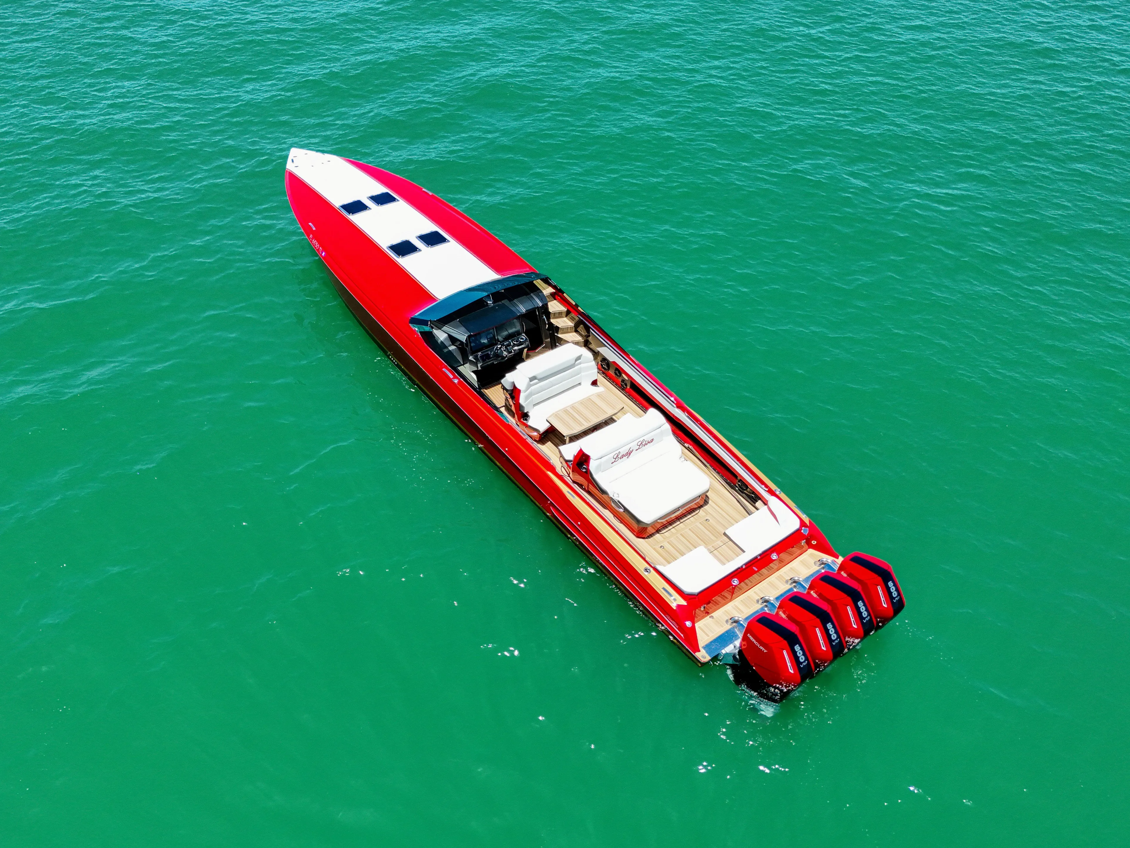 Lady Lisa Yacht Photos Pics 2023 Nor-Tech 55 Flyer boat with red exterior on turquoise water.