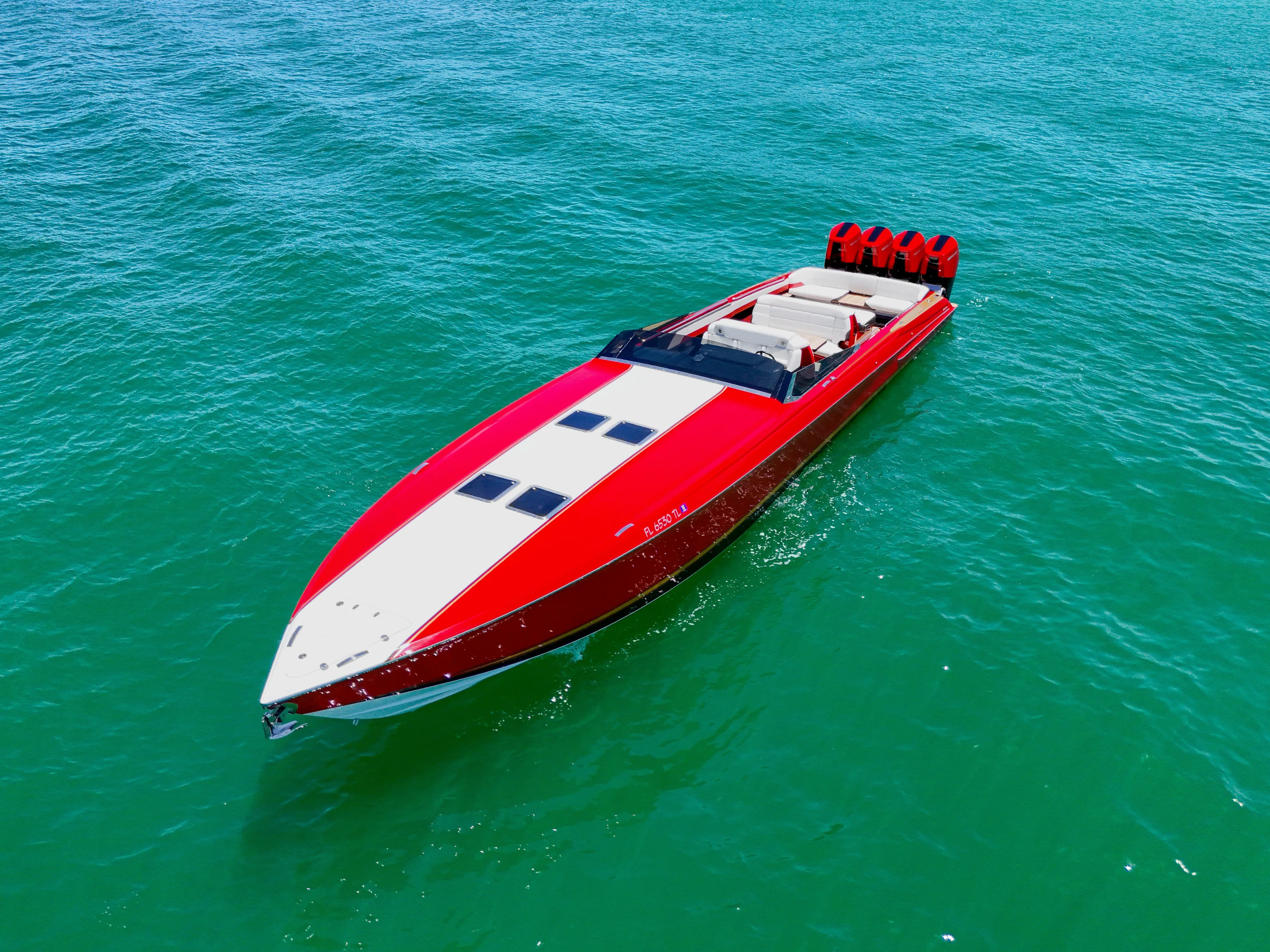 Lady Lisa Yacht Photos Pics 2023 Nor-Tech 55 Flyer speedboat on clear blue water, showcasing sleek red design.