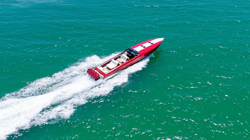 Lady Lisa Yacht Photos Pics 2023 Nor-Tech 55 Flyer speedboat cruising on turquoise water.