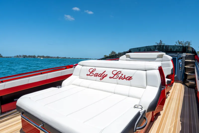 Lady Lisa Yacht Photos Pics 2023 Nor-Tech 55 Flyer luxury boat with "Lady Lisa" embroidered seating, cruising on a sunny day.