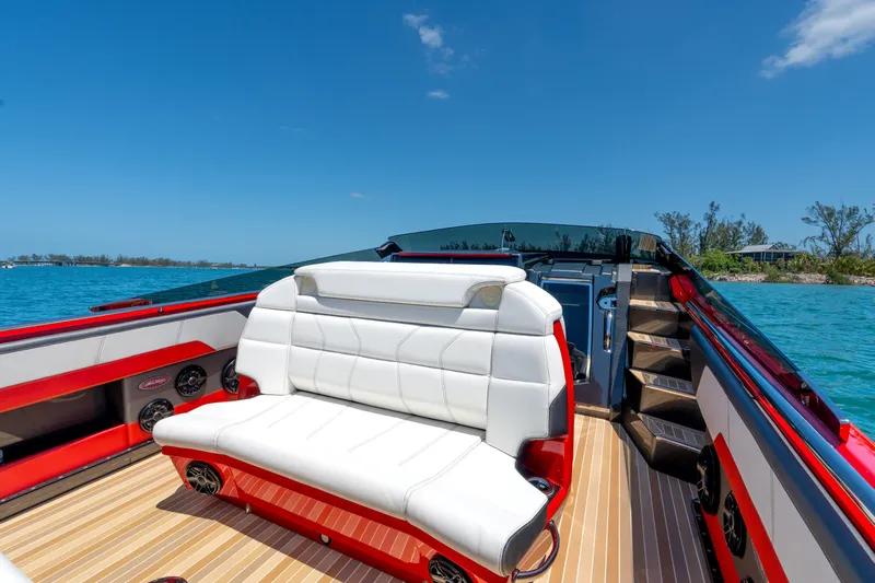 Lady Lisa Yacht Photos Pics Luxurious 2023 Nor-Tech 55 Flyer boat interior with white seating, red accents, and scenic ocean view.