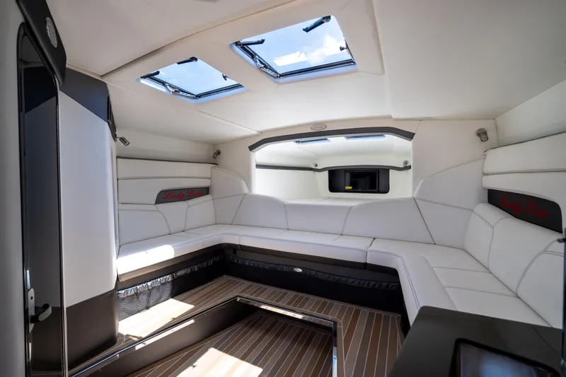 Lady Lisa Yacht Photos Pics Luxurious interior of 2023 Nor-Tech 55 Flyer boat with sleek white seating and skylights.