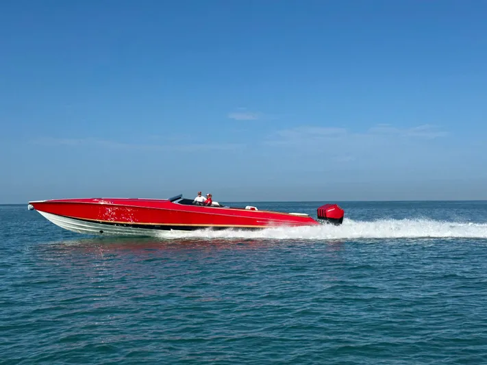 Lady Lisa Yacht Photos Pics Red 2023 Nor-Tech 55 Flyer speedboat cruising on open water under clear blue sky.