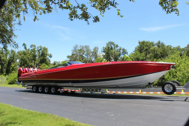 Lady Lisa Yacht Photos Pics 2023 Nor-Tech 55 Flyer boat on trailer, vibrant red, parked outdoors.