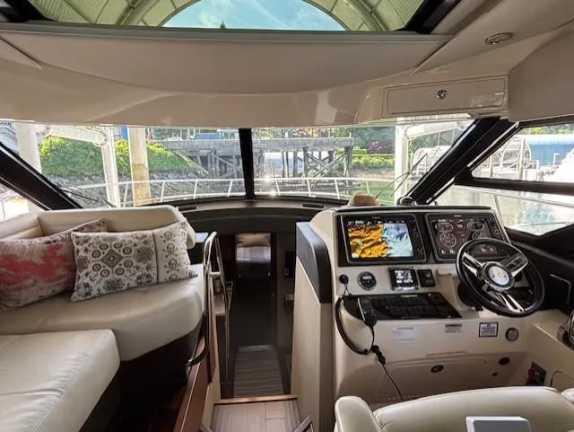 Va Bene Yacht Photos Pics Interior view of 2015 Sea Ray 470 Sundancer yacht cockpit with modern controls and seating.