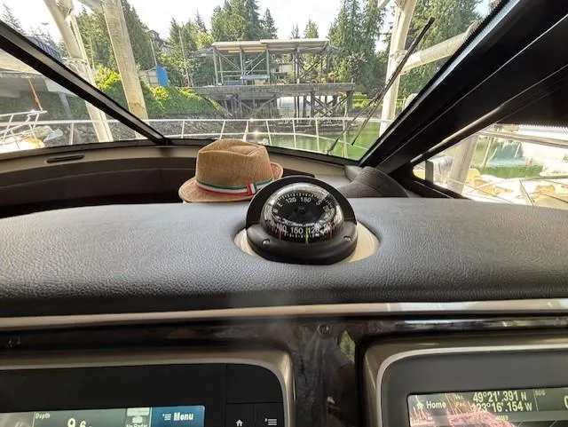 Va Bene Yacht Photos Pics Dashboard view of 2015 Sea Ray 470 Sundancer with compass and hat.