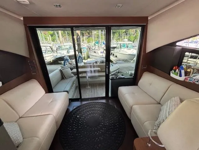 Va Bene Yacht Photos Pics Interior of 2015 Sea Ray 470 Sundancer yacht with plush seating and marina view.
