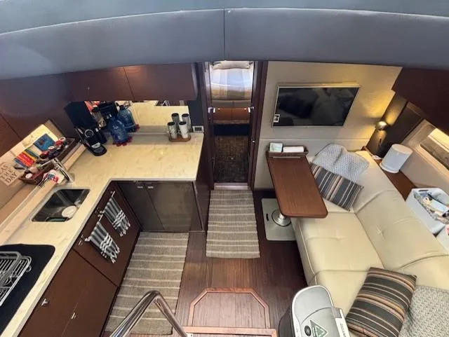 Va Bene Yacht Photos Pics Interior of 2015 Sea Ray 470 Sundancer yacht with kitchen and seating area.