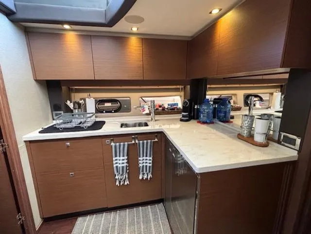 Va Bene Yacht Photos Pics Modern kitchen interior of 2015 Sea Ray 470 Sundancer yacht with sleek cabinetry and appliances.
