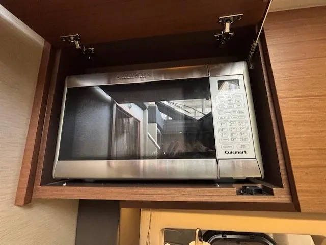 Va Bene Yacht Photos Pics Cuisinart microwave in a 2015 Sea Ray 470 Sundancer yacht's wooden cabinet.