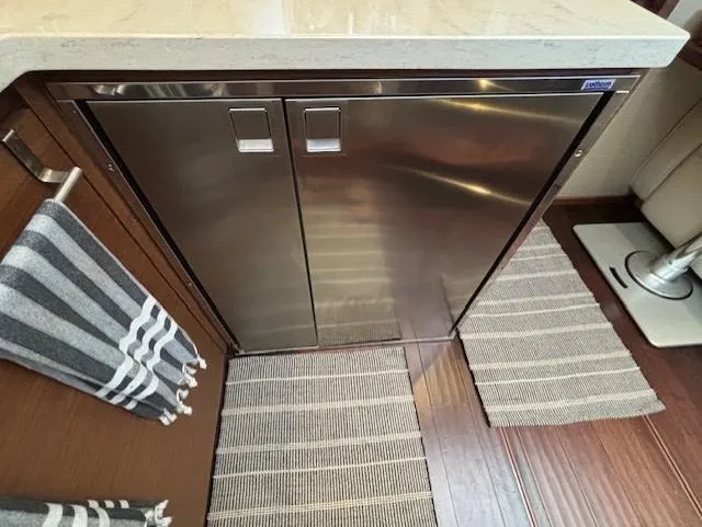 Va Bene Yacht Photos Pics Stainless steel fridge in 2015 Sea Ray 470 Sundancer yacht kitchen with striped towels and rugs.