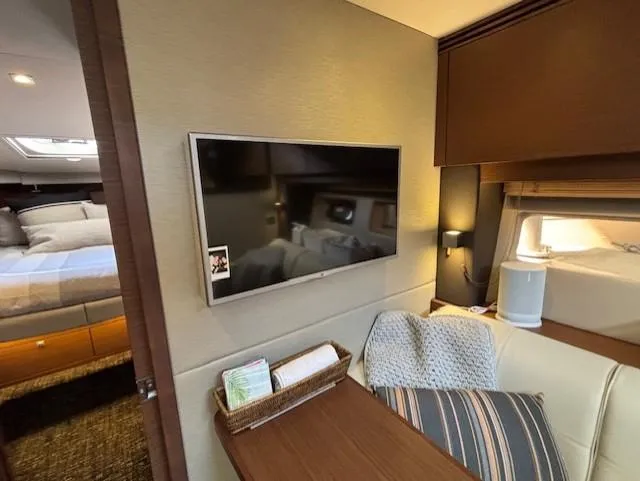 Va Bene Yacht Photos Pics Luxurious interior of 2015 Sea Ray 470 Sundancer yacht with TV and cozy seating area.