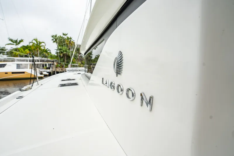  Yacht Photos Pics 2022 Lagoon 46 catamaran docked, showcasing sleek design and branding.