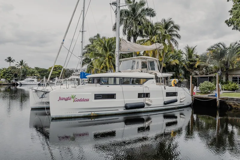  Yacht Photos Pics 2022 Lagoon 46 catamaran "Jungle Goddess" docked by tropical palm trees.