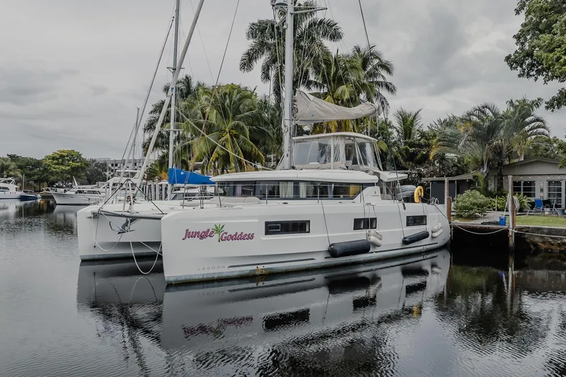  Yacht Photos Pics 2022 Lagoon 46 catamaran "Jungle Goddess" docked by tropical trees.