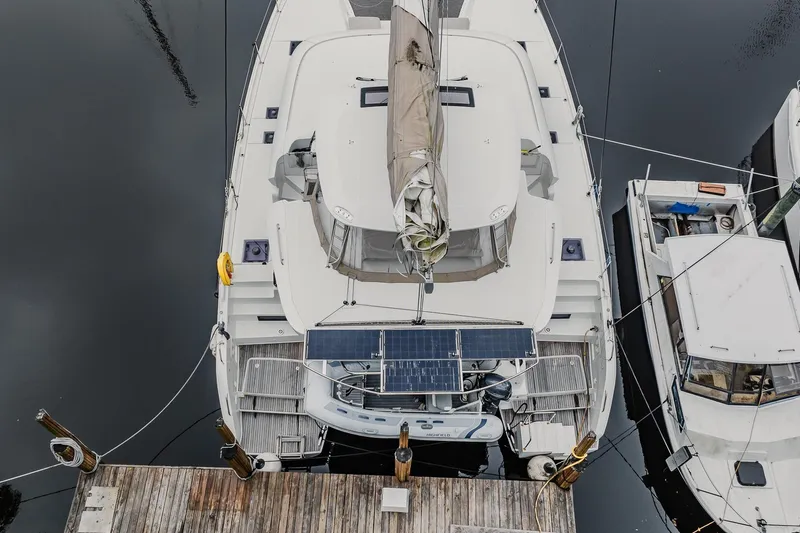  Yacht Photos Pics Aerial view of 2022 Lagoon 46 catamaran docked, featuring solar panels and sleek design.
