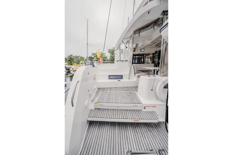  Yacht Photos Pics 2022 Lagoon 46 yacht deck with modern design and spacious seating area.